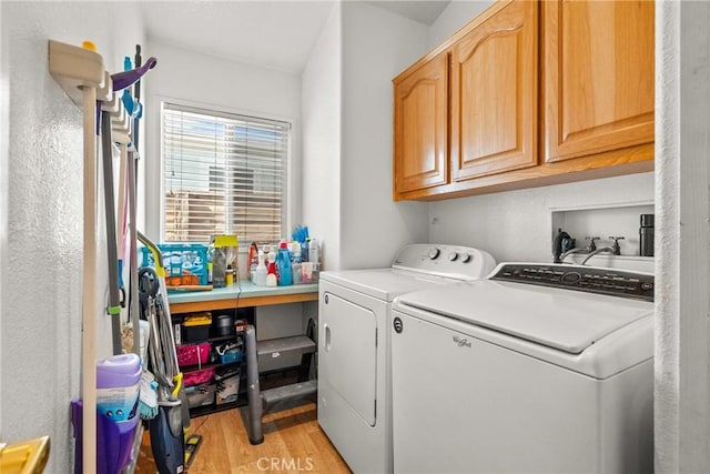 27828 Spyglass Ln, Canyon Country, CA 91351 - washroom featuring cabinet space, separate washer and dryer, and light wood-type flooring