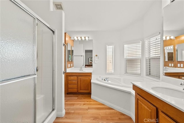 27828 Spyglass Ln, Canyon Country, CA 91351 - full bath with a shower stall, a sink, a garden tub, and wood finished floors