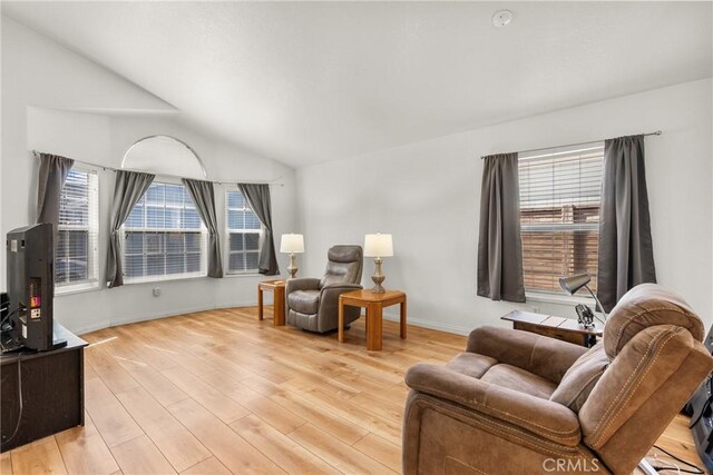 27828 Spyglass Ln, Canyon Country, CA 91351 - living area with baseboards, a wealth of natural light, light wood finished floors, and lofted ceiling
