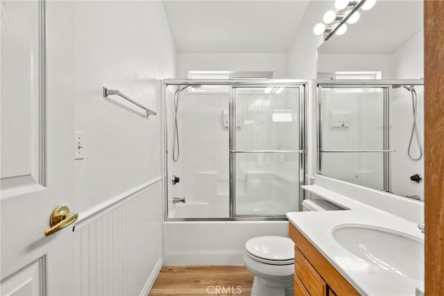 27828 Spyglass Ln, Canyon Country, CA 91351 - bathroom featuring shower / bath combination with glass door, toilet, wood finished floors, and vanity