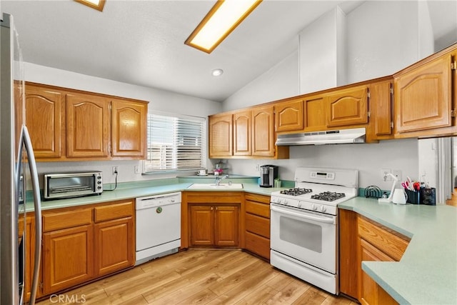 27828 Spyglass Ln, Canyon Country, CA 91351 - kitchen with light countertops, light wood finished floors, under cabinet range hood, and white appliances