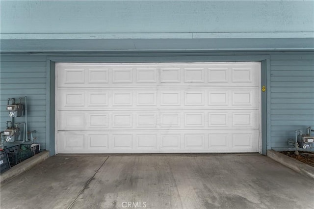 garage featuring concrete driveway