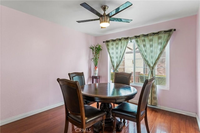 dining area featuring wood finished floors, baseboards, and ceiling fan