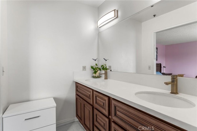 full bathroom featuring a sink and double vanity
