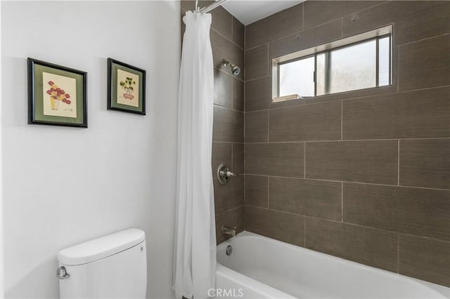 full bath featuring shower / tub combo with curtain and toilet