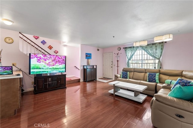 living area with baseboards and dark wood finished floors