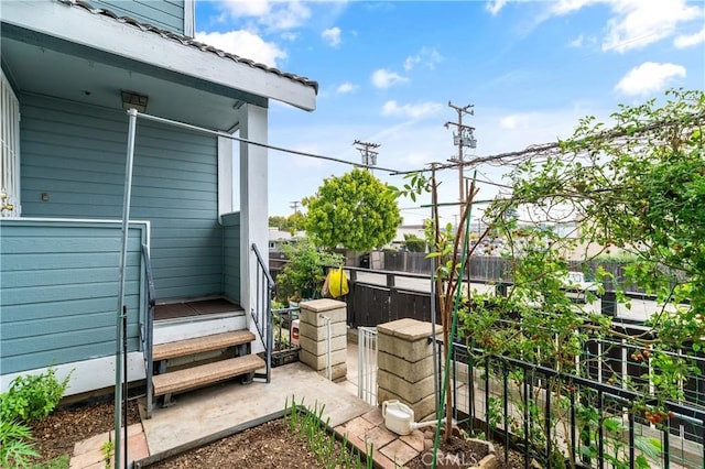 view of side of home featuring fence