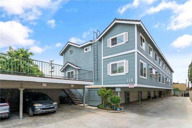 exterior space with covered parking and stairs