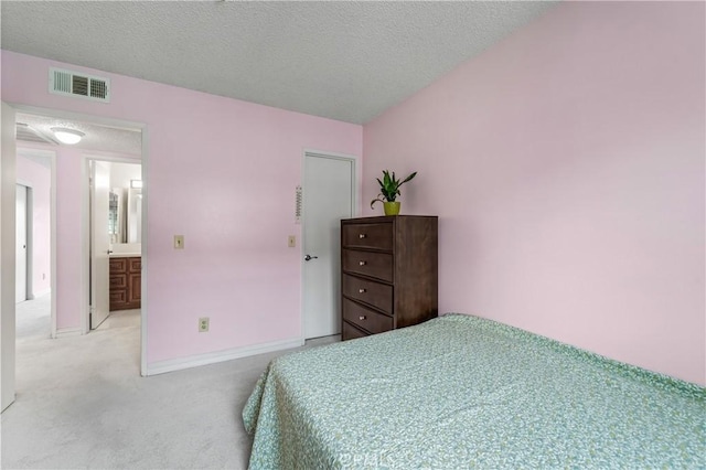 bedroom featuring light colored carpet, a textured ceiling, visible vents, and baseboards