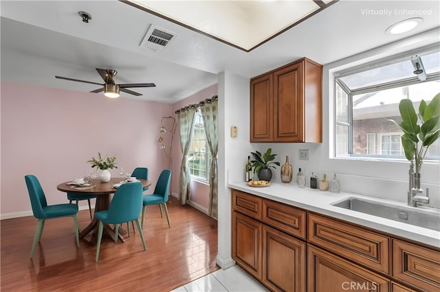 119 N Alhambra Ave Unit D, Monterey Park, CA 91755 - kitchen with brown cabinets, light countertops, a ceiling fan, and light wood-style flooring