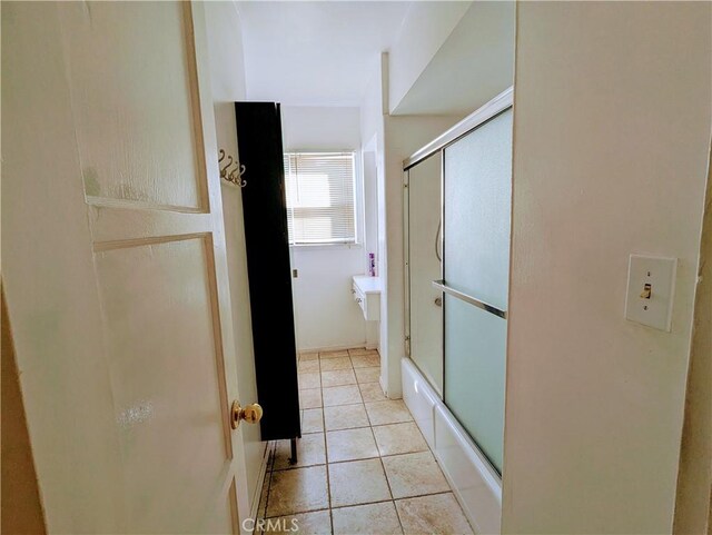 full bathroom with tile patterned flooring and bath / shower combo with glass door