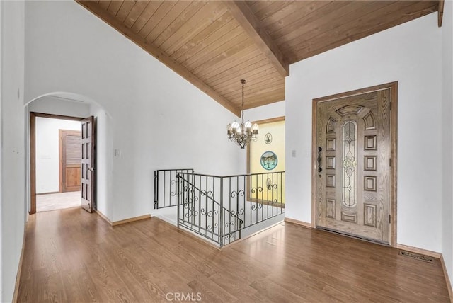 30062 Grandpoint Ln, Rancho Palos Verdes, CA 90275 - hall featuring arched walkways, wood finished floors, a chandelier, wooden ceiling with exposed beams, and baseboards