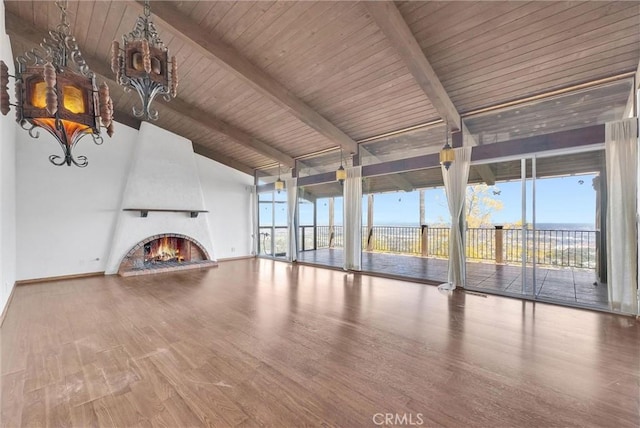 30062 Grandpoint Ln, Rancho Palos Verdes, CA 90275 - unfurnished living room featuring a chandelier, beam ceiling, a water view, wood finished floors, and a large fireplace
