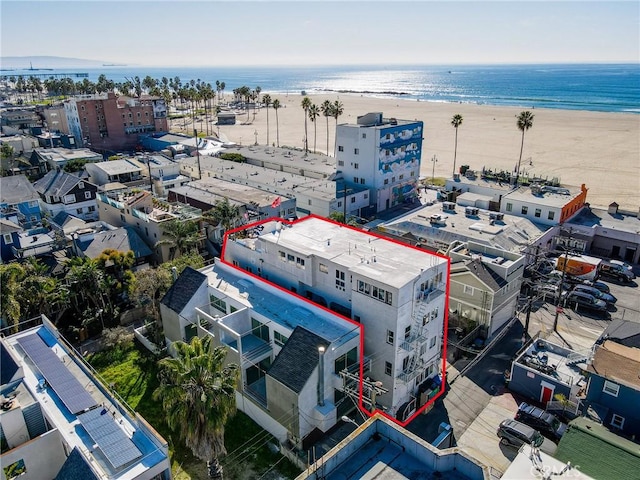 birds eye view of property featuring a beach view and a water view