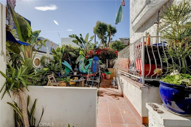 view of patio / terrace featuring stairs and fence