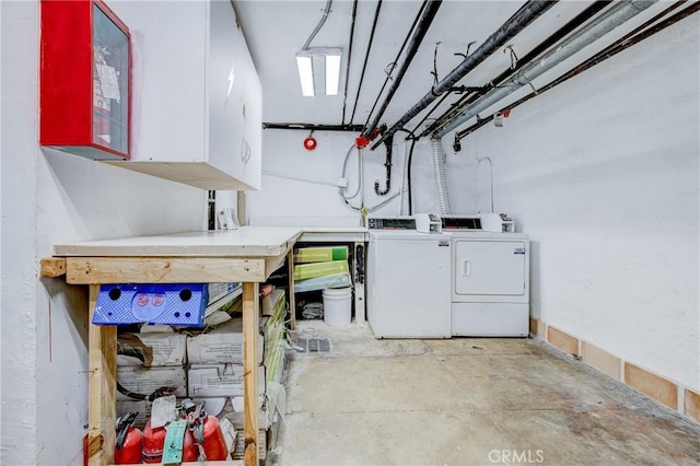 laundry room featuring a workshop area and washing machine and clothes dryer