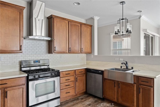 15427 Park Point Ave Unit 110, Lake Elsinore, CA 92532 - kitchen featuring stainless steel appliances, wall chimney exhaust hood, a sink, crown molding, and a chandelier