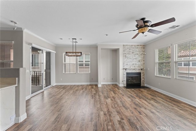 15427 Park Point Ave Unit 110, Lake Elsinore, CA 92532 - unfurnished living room featuring ceiling fan, wood finished floors, ornamental molding, a fireplace, and baseboards