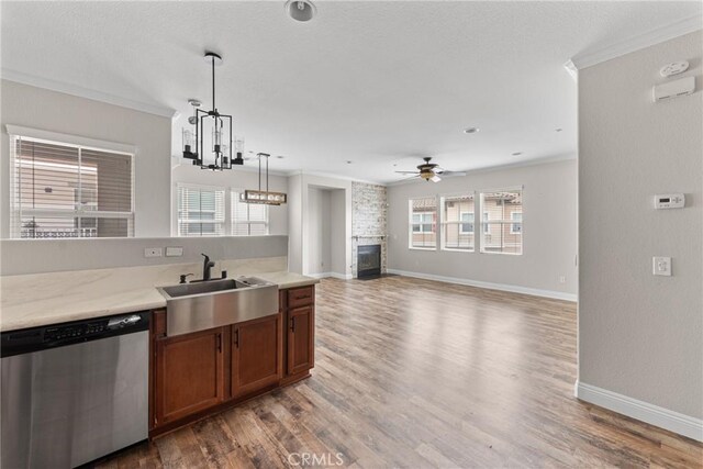 15427 Park Point Ave Unit 110, Lake Elsinore, CA 92532 - kitchen with stainless steel dishwasher, a sink, ornamental molding, a fireplace, and a ceiling fan
