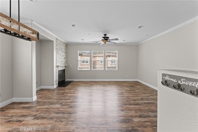 15427 Park Point Ave Unit 110, Lake Elsinore, CA 92532 - unfurnished living room with ceiling fan, ornamental molding, a stone fireplace, wood finished floors, and baseboards