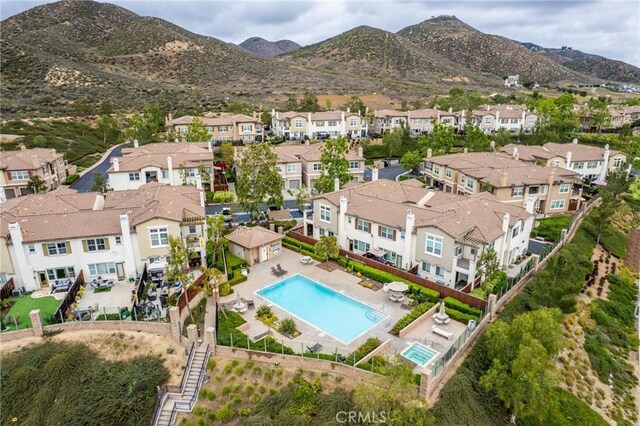 15427 Park Point Ave Unit 110, Lake Elsinore, CA 92532 - aerial view of property and surrounding area featuring nearby suburban area, a pool area, and a mountainous background