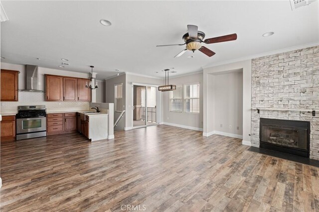 15427 Park Point Ave Unit 110, Lake Elsinore, CA 92532 - unfurnished living room with ceiling fan, ornamental molding, dark wood-style flooring, baseboards, and a fireplace