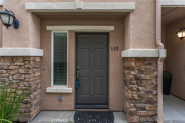 15427 Park Point Ave Unit 110, Lake Elsinore, CA 92532 - entrance to property featuring stone siding and stucco siding