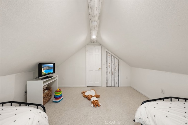 carpeted bedroom with baseboards and vaulted ceiling