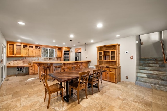 dining area with stairs, recessed lighting, and stone tile flooring