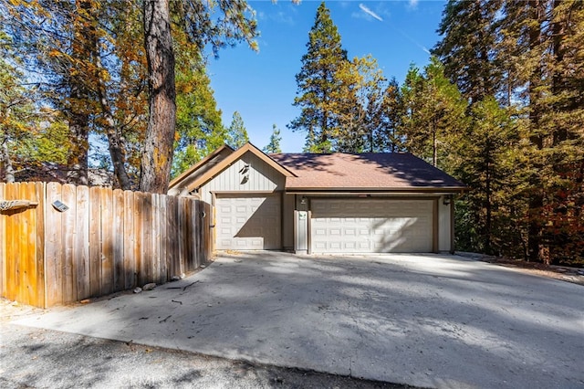 detached garage featuring fence
