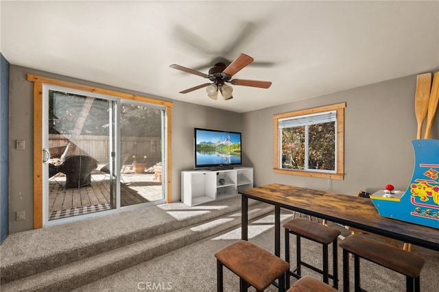 living room featuring carpet floors and ceiling fan