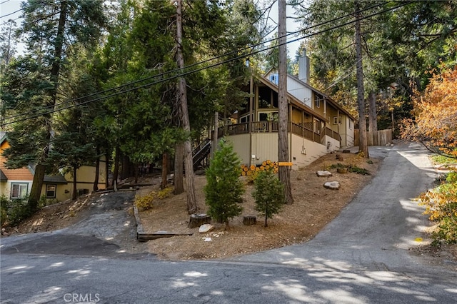 view of side of property featuring a chimney and stairway