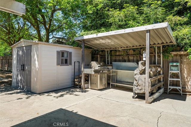 9137 Midway, Durham, CA 95938 - view of patio featuring fence, an outbuilding, a shed, and a grill