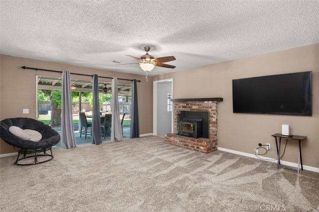 9137 Midway, Durham, CA 95938 - carpeted living area featuring baseboards, ceiling fan, a wood stove, and a textured ceiling