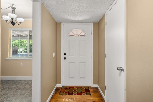 9137 Midway, Durham, CA 95938 - foyer entrance with a textured ceiling, a chandelier, and baseboards
