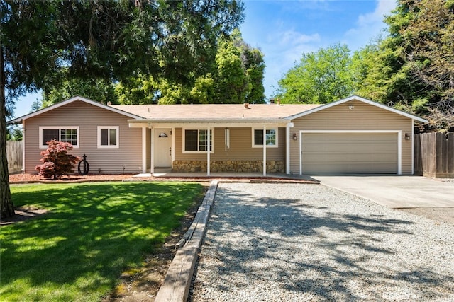 9137 Midway, Durham, CA 95938 - ranch-style house featuring a garage, a front lawn, fence, stone siding, and driveway