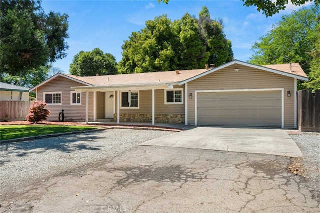 9137 Midway, Durham, CA 95938 - ranch-style home featuring fence, an attached garage, driveway, and stone siding