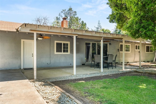 9137 Midway, Durham, CA 95938 - rear view of property with a yard, a patio, stucco siding, and a chimney