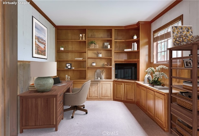office featuring crown molding, light carpet, and built in desk