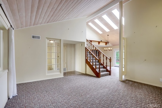 unfurnished living room featuring high vaulted ceiling, carpet flooring, stairs, and visible vents