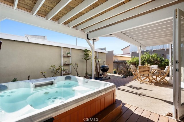 exterior space with a hot tub and a wooden deck