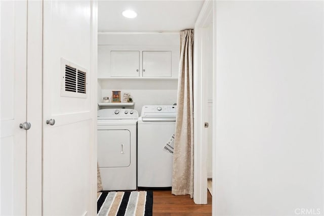 laundry room with separate washer and dryer, recessed lighting, wood finished floors, and visible vents