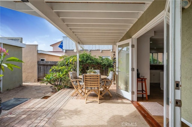 view of patio featuring fence and outdoor dining space