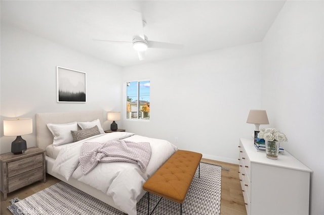 bedroom featuring light wood-style floors, baseboards, and ceiling fan