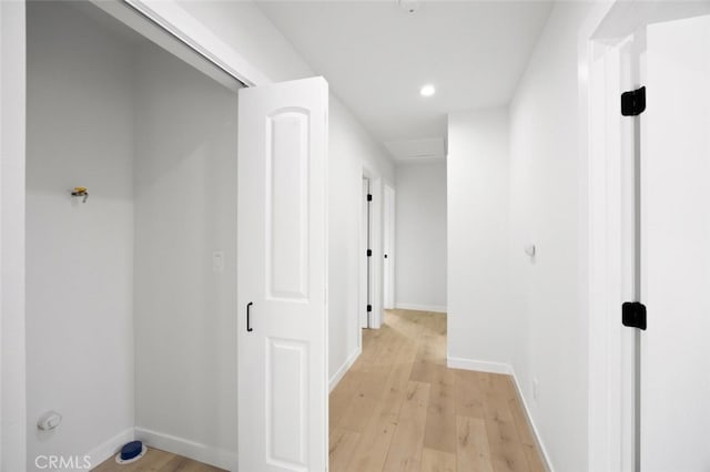 hall with baseboards, recessed lighting, and light wood-style flooring