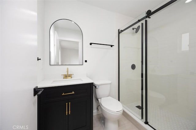 full bath featuring vanity, a stall shower, and toilet