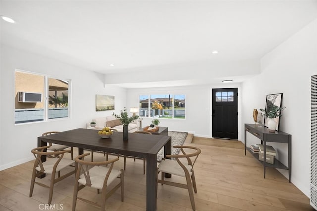 dining space with recessed lighting, baseboards, and light wood-type flooring