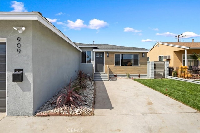 view of front of property with fence and stucco siding