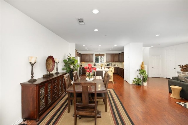 dining space with recessed lighting, wood finished floors, and visible vents
