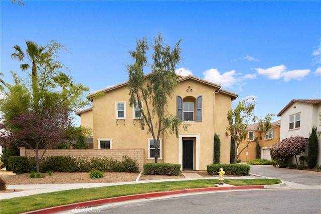 view of front of home featuring fence and stucco siding